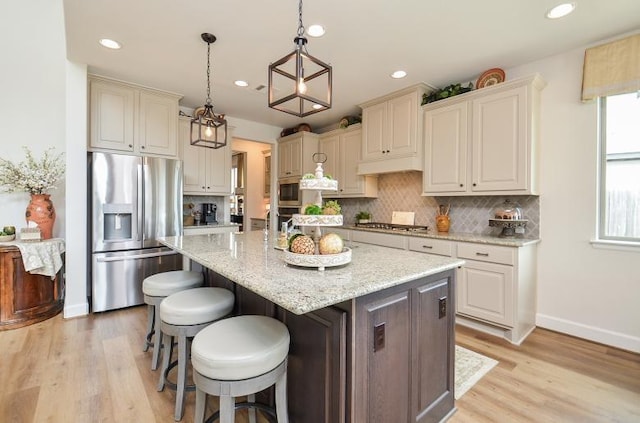 2038 Green Haven Ct, Missouri City, TX 77459 - kitchen with appliances with stainless steel finishes, decorative backsplash, light wood-type flooring, an island with sink, and recessed lighting