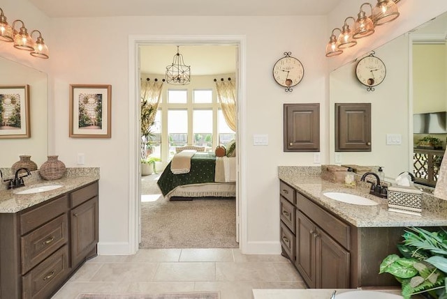 2038 Green Haven Ct, Missouri City, TX 77459 - full bath with a chandelier, two vanities, baseboards, and ensuite bath