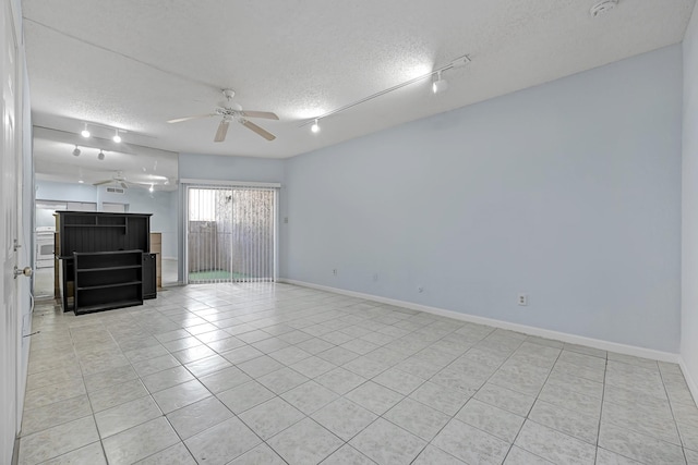 10855 Meadowglen Ln Unit 806, Houston, TX 77042 - unfurnished living room with a textured ceiling, ceiling fan, light tile patterned flooring, and baseboards