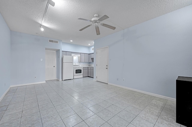 10855 Meadowglen Ln Unit 806, Houston, TX 77042 - unfurnished living room featuring a textured ceiling, ceiling fan, light tile patterned floors, and baseboards
