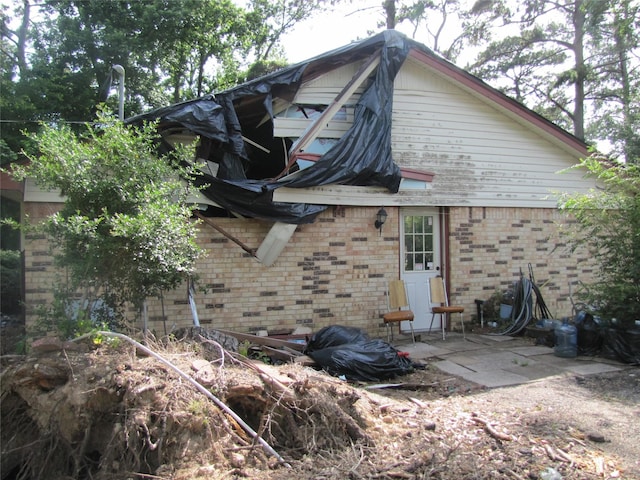 21315 Greengate Dr, Spring, TX 77388 - view of side of home featuring brick siding and a patio