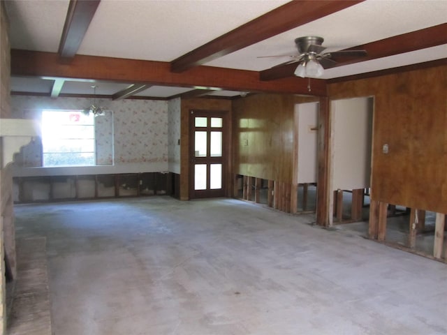 21315 Greengate Dr, Spring, TX 77388 - spare room with plenty of natural light, wallpapered walls, beam ceiling, wood walls, and ceiling fan