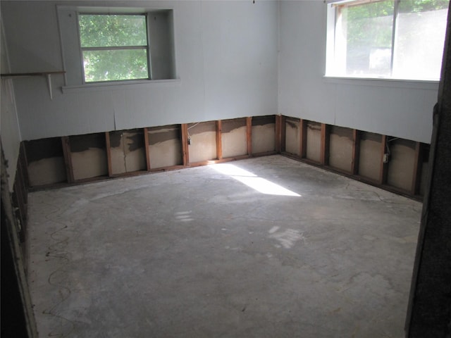 21315 Greengate Dr, Spring, TX 77388 - empty room with healthy amount of natural light and unfinished concrete floors