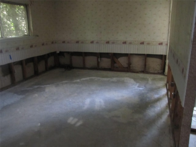 21315 Greengate Dr, Spring, TX 77388 - empty room with wallpapered walls and concrete flooring
