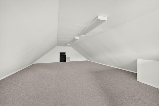 11108 Dawson Rd, Pearland, TX 77584 - additional living space featuring vaulted ceiling, carpet flooring, and baseboards
