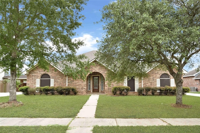 11108 Dawson Rd, Pearland, TX 77584 - view of front of home with brick siding, central AC unit, and a front lawn