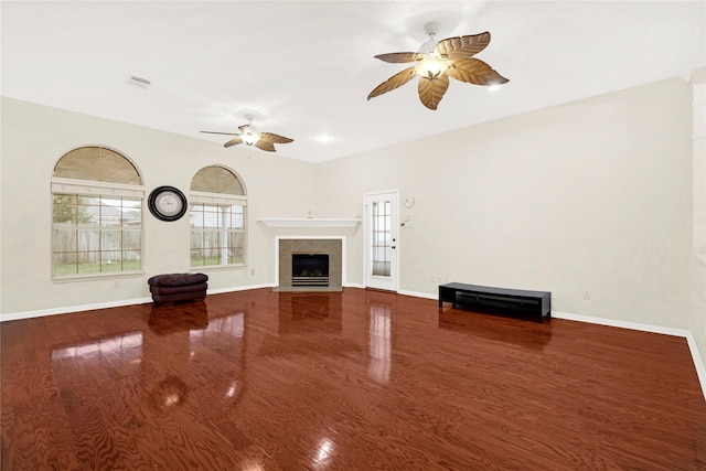 11108 Dawson Rd, Pearland, TX 77584 - unfurnished living room with ceiling fan, wood finished floors, a tile fireplace, and baseboards