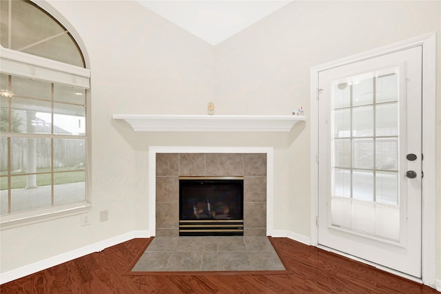 11108 Dawson Rd, Pearland, TX 77584 - unfurnished living room with a tile fireplace, wood finished floors, and baseboards
