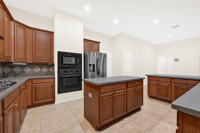 11108 Dawson Rd, Pearland, TX 77584 - kitchen featuring black appliances, dark countertops, a kitchen island, tasteful backsplash, and light tile patterned floors