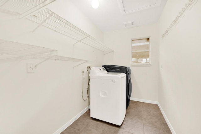 11108 Dawson Rd, Pearland, TX 77584 - washroom with washer and clothes dryer, light tile patterned floors, baseboards, and attic access