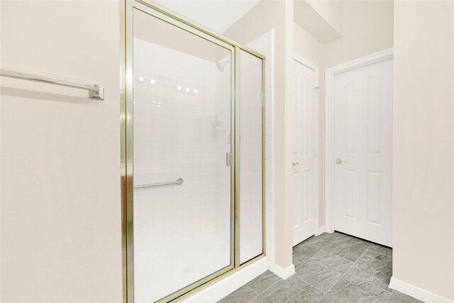 11108 Dawson Rd, Pearland, TX 77584 - full bathroom with a stall shower, baseboards, and marble finish flooring