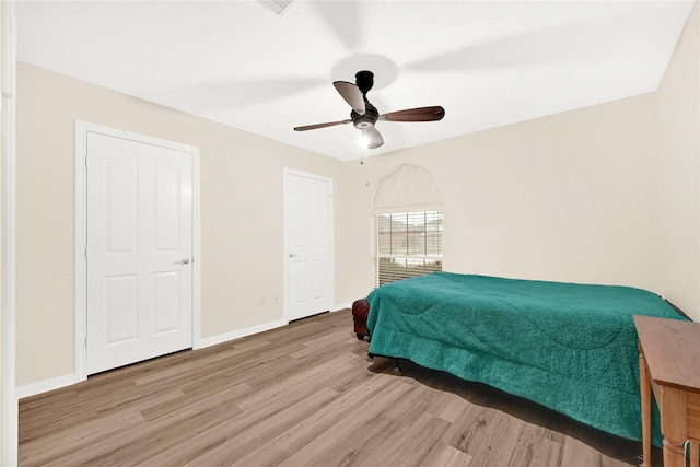 11108 Dawson Rd, Pearland, TX 77584 - bedroom with wood finished floors, baseboards, and a ceiling fan
