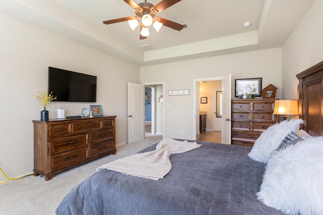10518 Kicking Horse Pass, Cypress, TX 77433 - bedroom with light carpet, baseboards, a raised ceiling, ceiling fan, and ensuite bath