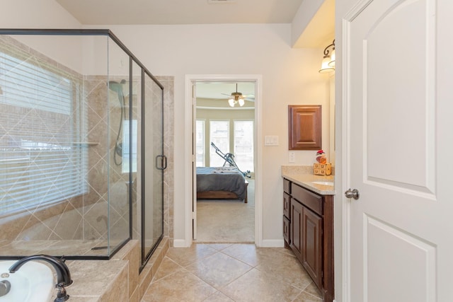 10518 Kicking Horse Pass, Cypress, TX 77433 - ensuite bathroom with vanity, a stall shower, tile patterned floors, a garden tub, and baseboards