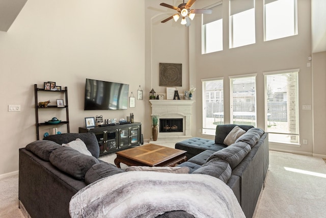 10518 Kicking Horse Pass, Cypress, TX 77433 - living area featuring light carpet, a towering ceiling, baseboards, ceiling fan, and healthy amount of natural light