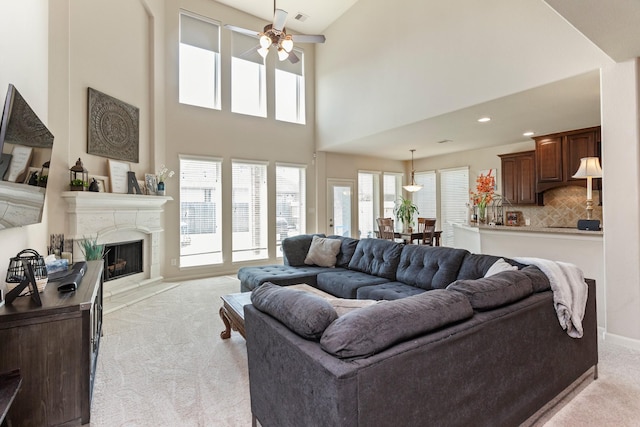 10518 Kicking Horse Pass, Cypress, TX 77433 - living room with light colored carpet, a premium fireplace, ceiling fan, plenty of natural light, and a high ceiling