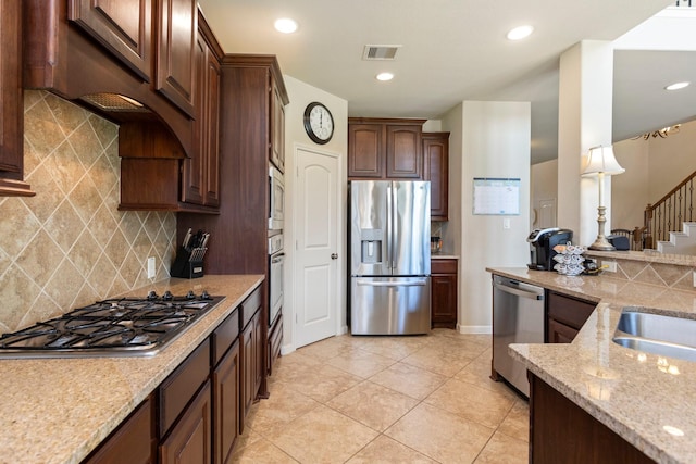 10518 Kicking Horse Pass, Cypress, TX 77433 - kitchen with appliances with stainless steel finishes, light stone countertops, backsplash, dark brown cabinets, and recessed lighting