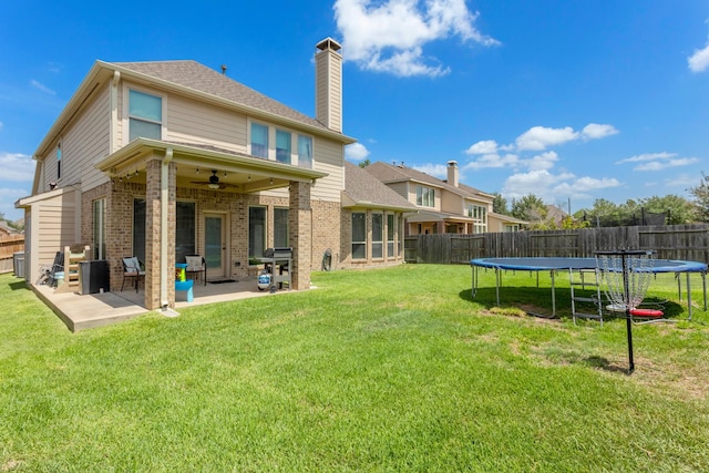 10518 Kicking Horse Pass, Cypress, TX 77433 - back of property featuring a trampoline, brick siding, and a ceiling fan