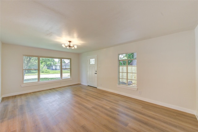 4914 Pershing St, Houston, TX 77033 - entrance foyer with a chandelier, healthy amount of natural light, baseboards, and light wood-style floors