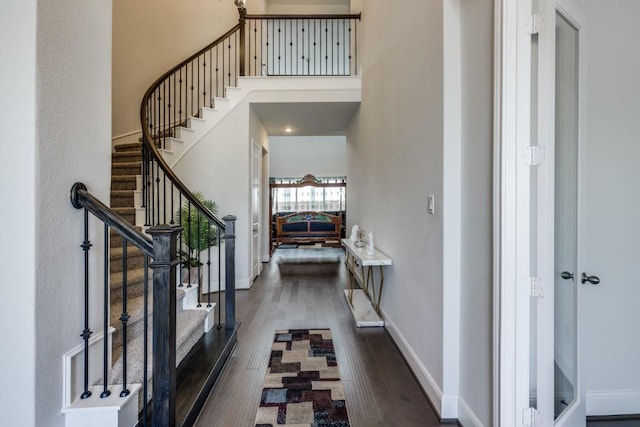 14303 Paseo Marbella Dr, Cypress, TX 77433 - foyer with dark wood-type flooring, stairs, baseboards, and a towering ceiling