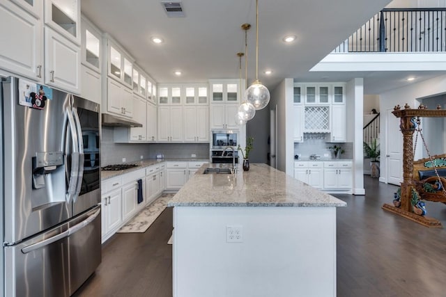 14303 Paseo Marbella Dr, Cypress, TX 77433 - kitchen featuring stainless steel appliances, a sink, an island with sink, tasteful backsplash, and dark wood-type flooring