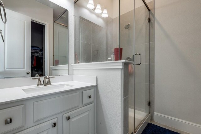 14303 Paseo Marbella Dr, Cypress, TX 77433 - bathroom with a stall shower, vanity, and a spacious closet