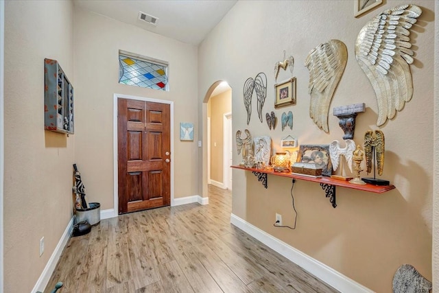 8323 Egret Bay Cir, Baytown, TX 77523 - foyer with arched walkways, wood finished floors, and baseboards