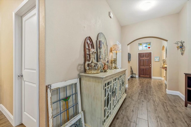 8323 Egret Bay Cir, Baytown, TX 77523 - foyer entrance with arched walkways, wood finished floors, and baseboards