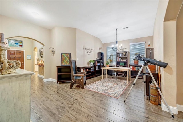 8323 Egret Bay Cir, Baytown, TX 77523 - living area featuring light wood-style floors, baseboards, a chandelier, arched walkways, and vaulted ceiling