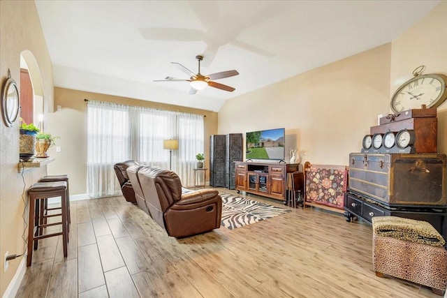 8323 Egret Bay Cir, Baytown, TX 77523 - living room featuring wood finished floors, ceiling fan, vaulted ceiling, and baseboards
