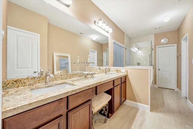 8323 Egret Bay Cir, Baytown, TX 77523 - bathroom featuring a stall shower, double vanity, and baseboards