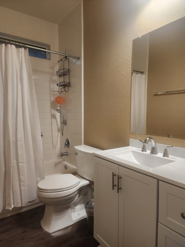 8323 Egret Bay Cir, Baytown, TX 77523 - bathroom with a textured wall, toilet, wood finished floors, vanity, and shower / bath combo with shower curtain