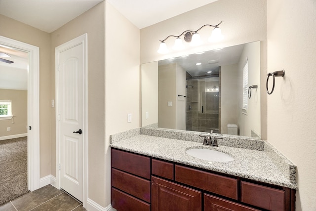 42 Brookefield Cir, Magnolia, TX 77355 - full bathroom with vanity, a stall shower, tile patterned floors, toilet, and baseboards