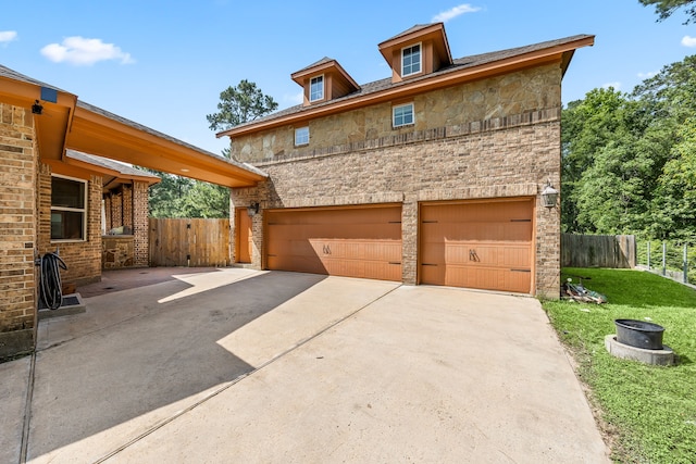 42 Brookefield Cir, Magnolia, TX 77355 - view of front of property with stone siding, an attached garage, and concrete driveway