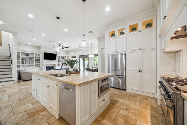 1249 Gardenia Dr, Houston, TX 77018 - kitchen featuring high end appliances, a sink, stone tile floors, recessed lighting, and a ceiling fan