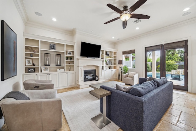 1249 Gardenia Dr, Houston, TX 77018 - living area with crown molding, a glass covered fireplace, a ceiling fan, stone tile floors, and recessed lighting
