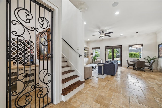 1249 Gardenia Dr, Houston, TX 77018 - stairway featuring crown molding, ceiling fan, baseboards, stone tile floors, and recessed lighting