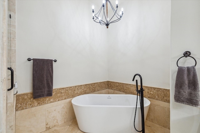 1249 Gardenia Dr, Houston, TX 77018 - bathroom featuring a wainscoted wall, a chandelier, a freestanding bath, tile patterned floors, and tile walls