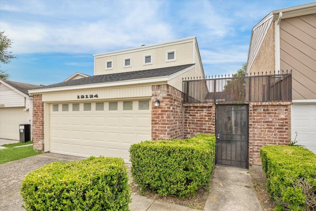12124 Burdine St, Houston, TX 77035 - view of front of house featuring brick siding, driveway, and a garage