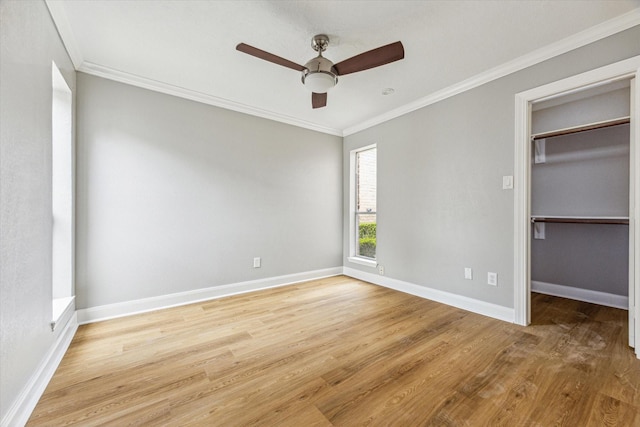 12124 Burdine St, Houston, TX 77035 - unfurnished bedroom featuring crown molding, light wood-style flooring, baseboards, a walk in closet, and ceiling fan