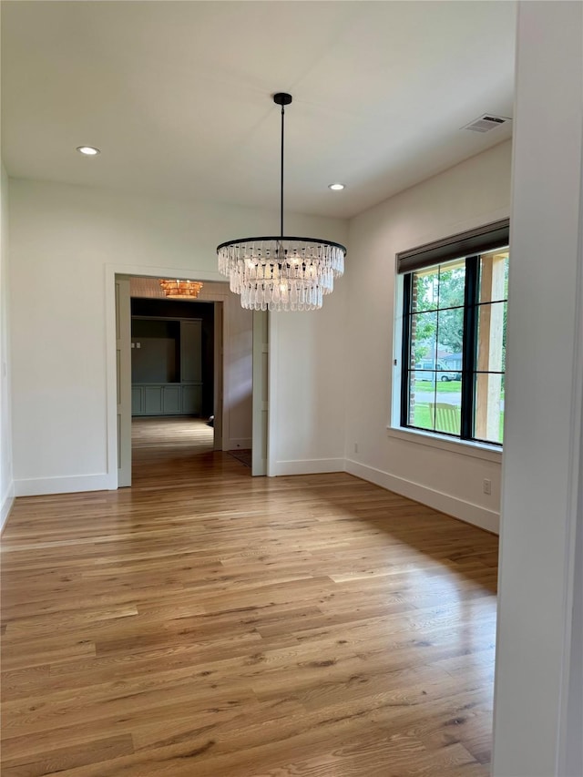 1701 Bayram Dr, Houston, TX 77055 - unfurnished dining area with baseboards, recessed lighting, light wood finished floors, and a chandelier