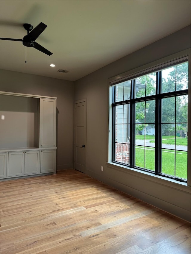 1701 Bayram Dr, Houston, TX 77055 - unfurnished bedroom with multiple windows, light wood finished floors, ceiling fan, and recessed lighting
