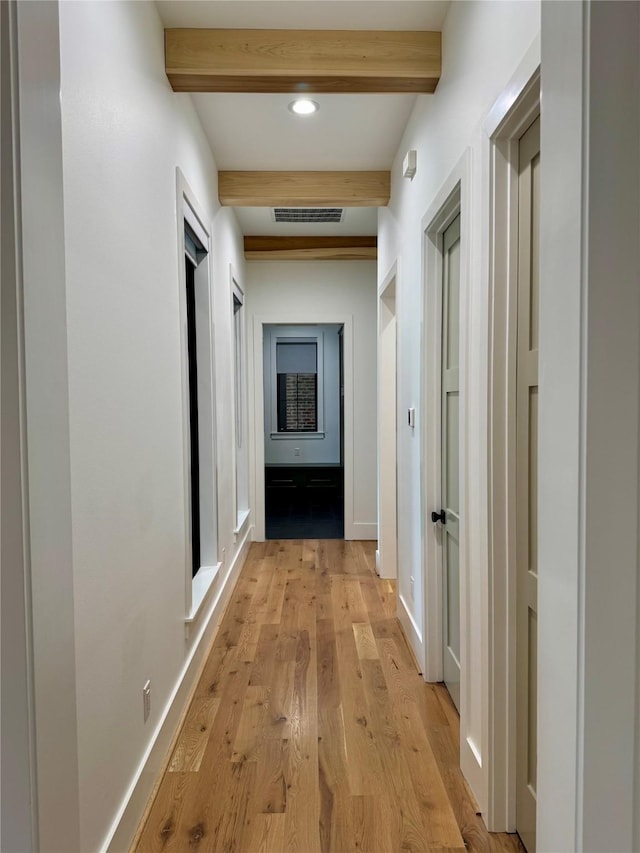 1701 Bayram Dr, Houston, TX 77055 - hallway featuring beamed ceiling, light wood-style floors, baseboards, and recessed lighting