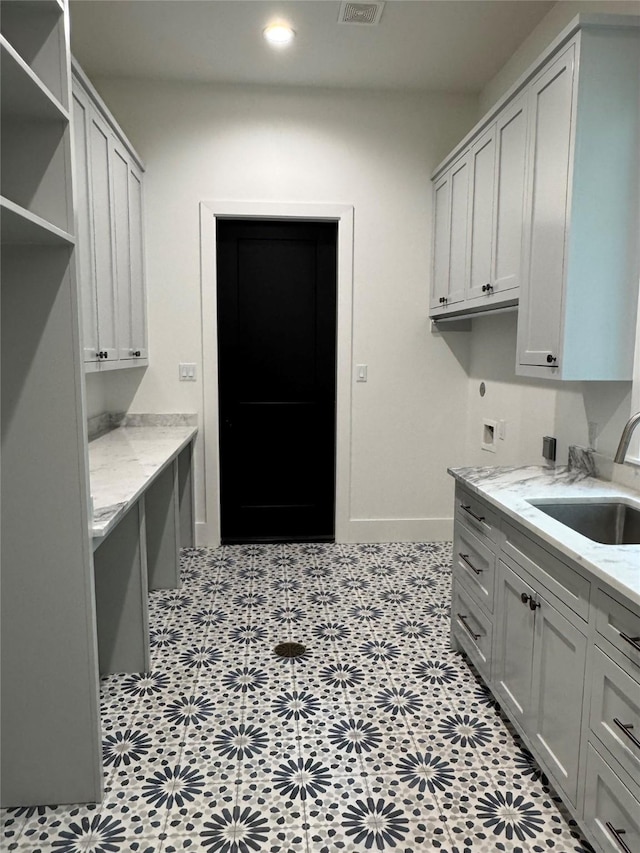 1701 Bayram Dr, Houston, TX 77055 - laundry room with recessed lighting, cabinet space, and baseboards