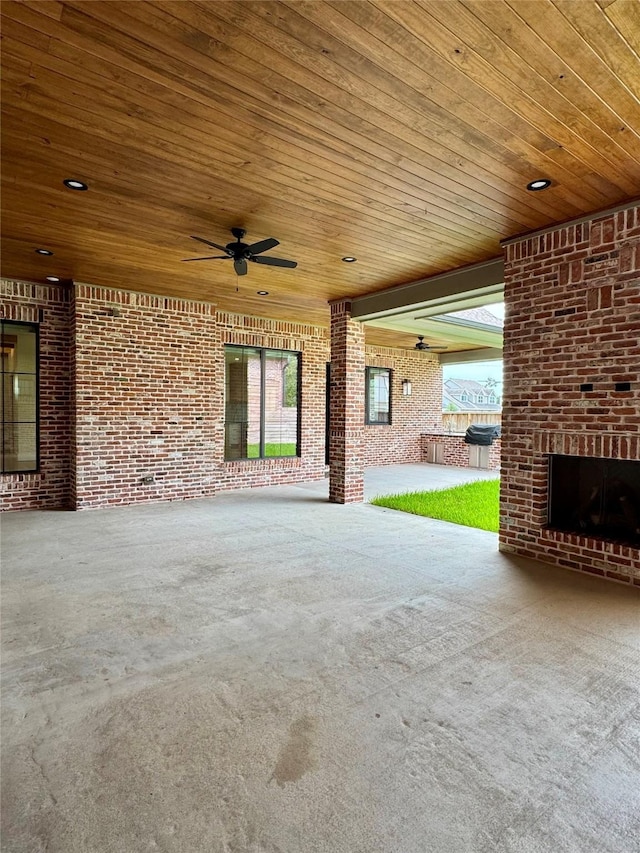 1701 Bayram Dr, Houston, TX 77055 - view of patio / terrace featuring ceiling fan and a fireplace