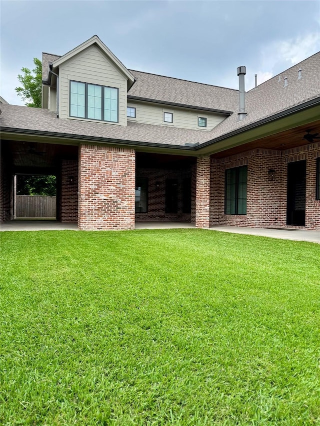 1701 Bayram Dr, Houston, TX 77055 - back of house featuring a lawn, brick siding, and roof with shingles