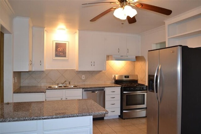 13907 Nitida St, Houston, TX 77045 - kitchen with stainless steel appliances, under cabinet range hood, a sink, ceiling fan, and white cabinets