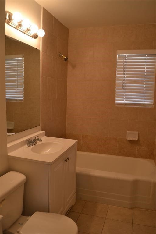 13907 Nitida St, Houston, TX 77045 - bathroom with tile patterned floors, toilet, vanity, and washtub / shower combination