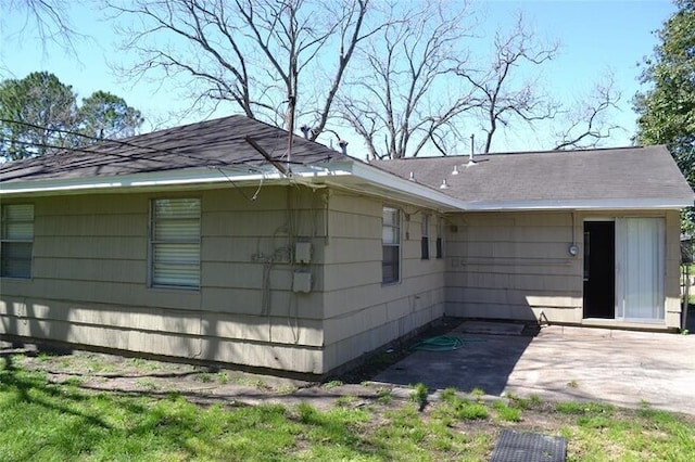 13907 Nitida St, Houston, TX 77045 - view of home's exterior featuring a patio area and roof with shingles