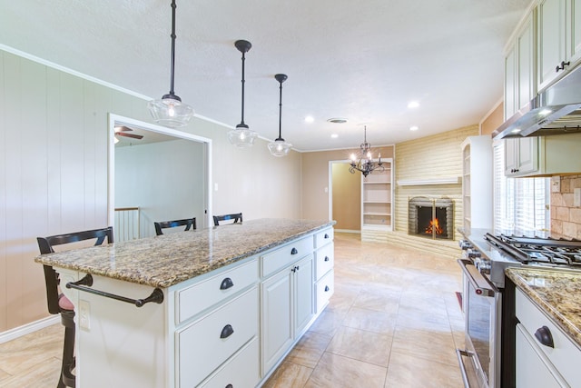 1708 Capstan Rd, Houston, TX 77062 - kitchen with high end stove, a center island, ornamental molding, under cabinet range hood, and light stone countertops